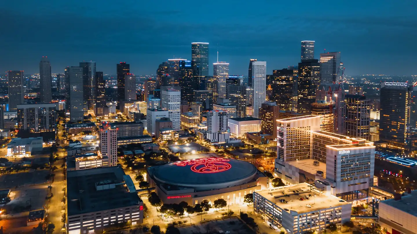 Downtown Houston from the air at dusk, the city behind our 2,000-answer study